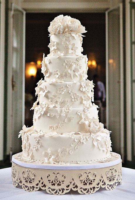 wedding cake with small white flowers featured in outstanding wedding